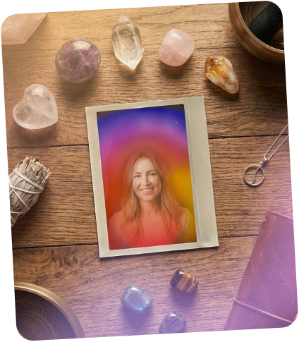 Colorful portrait print on a wooden table among crystals, a pendant and dried plants